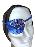 Women's high-fashion eye patch "MIDNIGHT MADNESS" is expertly handmade with blue metallic fabric overlaid with sequin fabric and adorned with 4 pearls. A matching elastic band and a soft backing of recycled fabric provide comfort. An exciting design that